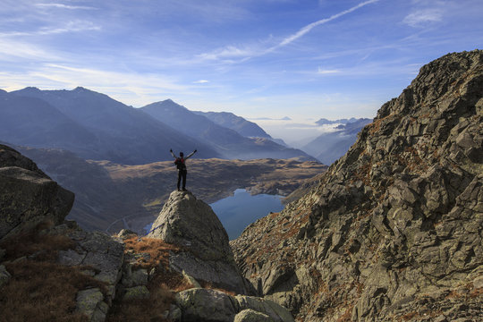Hiker admires Lake Montespluga from Pizzo Della Casa, Chiavenna Valley, Spluga Valley, Valtellina, Lombardy
