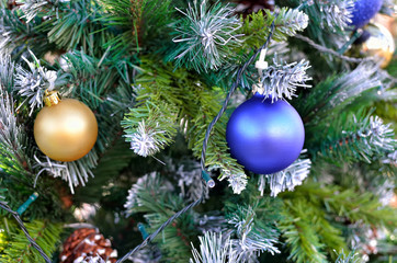 Green branches of the Christmas tree decorated with toys. New Year decoration.