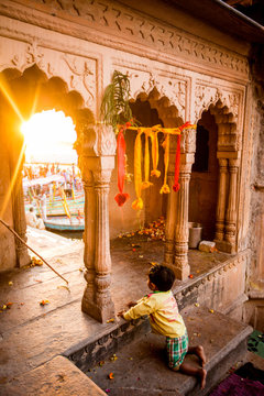 Little Indian boy watching the Traditional Krishna and Radha dance during the Flower Holi Festival, Vrindavan, Uttar Pradesh