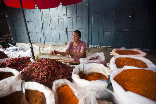 A woman selling spices on a market stall in Shan State