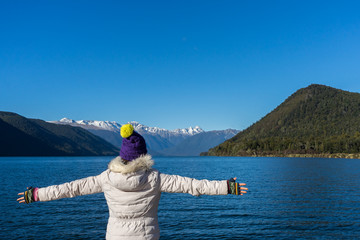 Woman enjoys the view of Lake Rotoroa in Nelson National Park