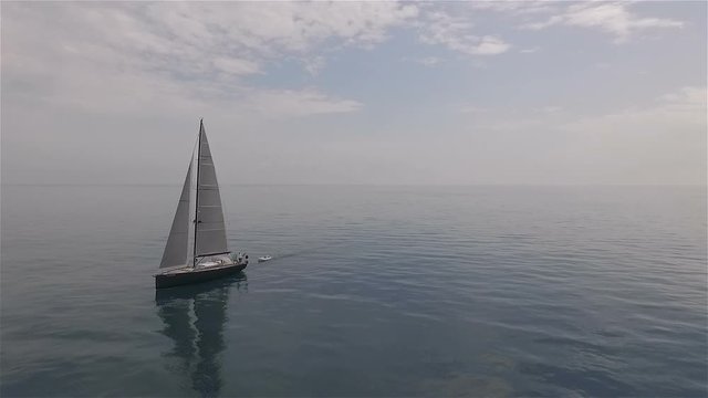 Aerial video of a sailing boat in the blue sea