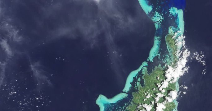 High-altitude overflight aerial of the Republic of Palau island chain, western Micronesia. Clip loops and is reversible. Elements of this image furnished by USGS/NASA Landsat