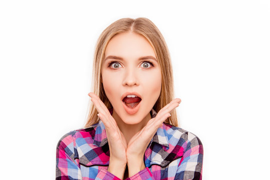 Portrait of happy shocked young woman with opened mouth touching