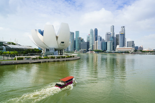 Singapore skyline, financial district skyscrapers with the lotus flower shaped ArtScience Museum in the foreground by Marina Bay, Singapore