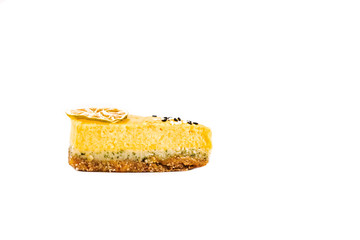 Isolated piece of raw lemon, orange, lime and mint cake on a white background. Layers view. Vegan, sugar, gluten, dairy free dessert.  Copy space