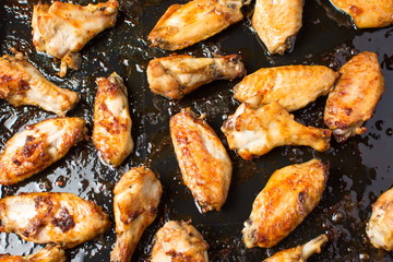 bbq chicken wings on a black plate