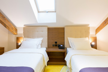 Fototapeta na wymiar Hotel bedroom interior in the loft apartment