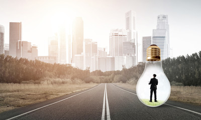Businessman inside light bulb