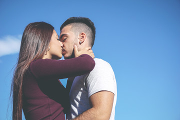 Hug of a romantic couple of teenager in love kissing passionately 