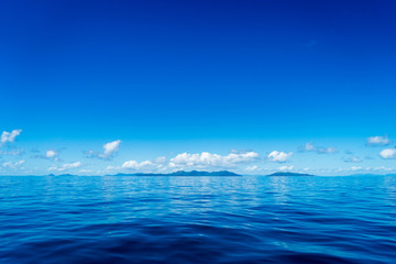 Blue sky and ocean with islands in the background, Queensland