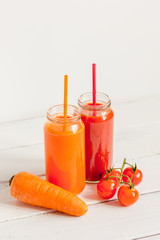 Fresh detox juices in glass bottles on white background