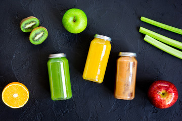 freshly squeezed juices for detox on dark background top view