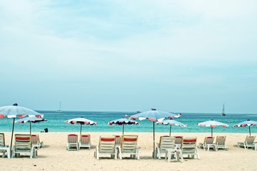 Fototapeta na wymiar Beds and umbrella on a tropical beach