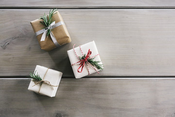 Overhead styled flat lay of three pretty Christmas Gifts space for text