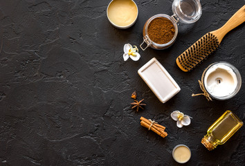 cosmetics for spa on dark background top view