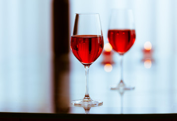 Pair of wine glasses on a restaurant table. 