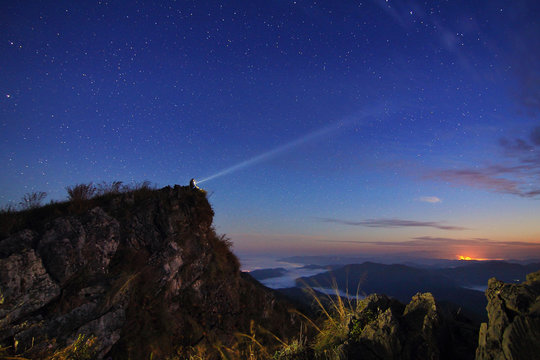 Beautiful scenery of the starry sky at night at Doi Pha Phung at Nan province in Thailand. Long exposure shooting and high iso used make this photo have noise