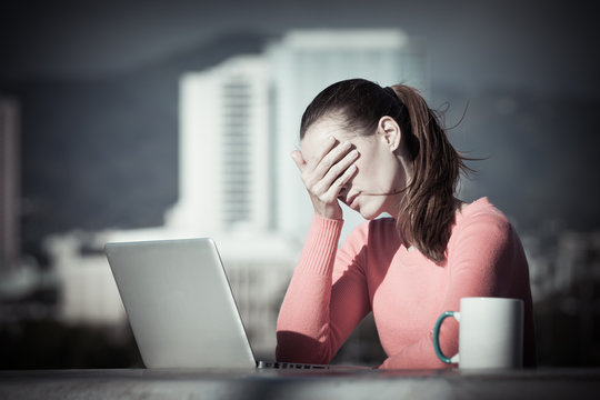 Stressed out businesswoman on her computer. Over worked concept. 