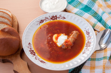 Plate of beetroot soup with sour cream on the table 