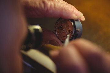 Horologist repairing a watch