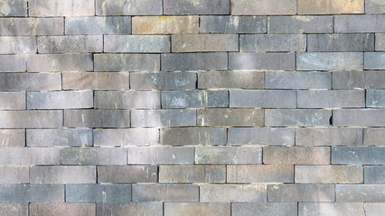 grey brickwall with sunlight