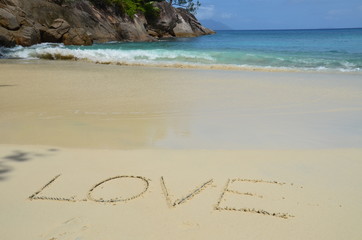 Sandy beach with "love" sign