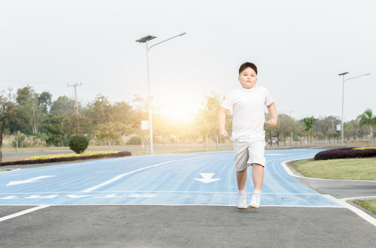 Obese Fat Boy Running On Park