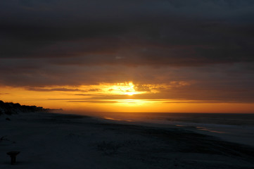 Fototapeta na wymiar Sunrise on a Cloudy Morning at the Beach