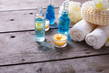 Bottles wih essential aroma oil, towels,  candles and wisps