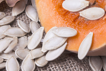 many scattered white pumpkin seeds on a pumpkin pulp