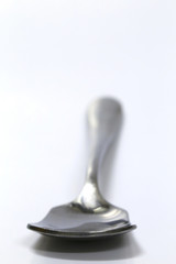Silver spoon over white. 