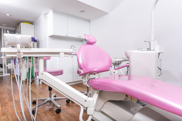 Dental office with pink dental chair..