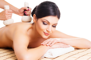 Obraz na płótnie Canvas Young woman relaxing on a spa massage procedure