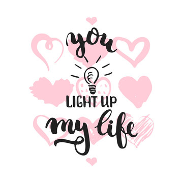 You light up my life - hand drawn lettering phrase isolated on the white background with hearts. Fun brush ink inscription for Valentines Day photo overlays, greeting card, poster design.