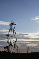 silhouette of oil rig at sunset the sun