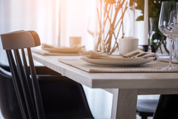 closed up nice dining chair with wooden table and dish sets inte