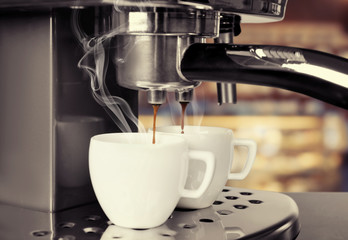 Preparing of aromatic espresso in modern coffee machine, closeup