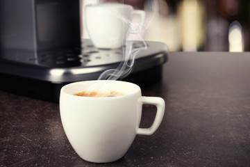 Cup of aromatic coffee on table, closeup