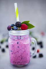 Delicious berry smoothie made with fresh ingredients on light background. 