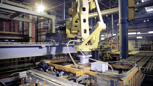 Robot working, packing goods at a industrial factory. HD.