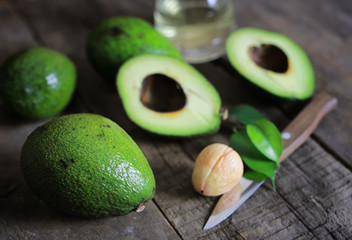 avocado and oil on wooden background