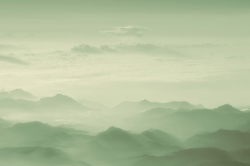 Obraz premium Misty autumn mountain hills landscape. A lone traveler walking along the trail.Filtered image:cross processed vintage effect...