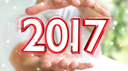 Businessman holding 2017 3D rendering text