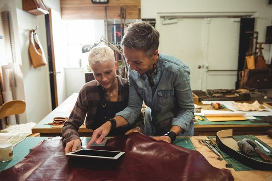 Craftswomen using digital tablet