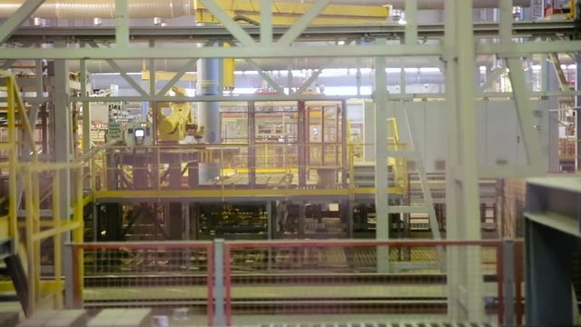 Modern factory equipment. Robots working at industrial factory. HD.