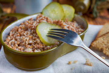 Military food with porridge and tea on old wooden boards close-up