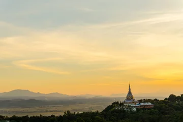 Fotobehang Tha Ton Temple set amid green mountains with sunset sky,Place for religious practices of Thailand © kedsirin
