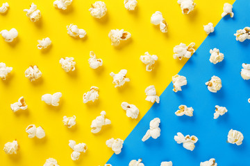 Popcorn pattern on yellow and blue background. Top view. Contrast concept