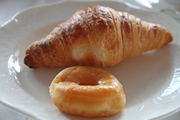 donut and croissant on plate